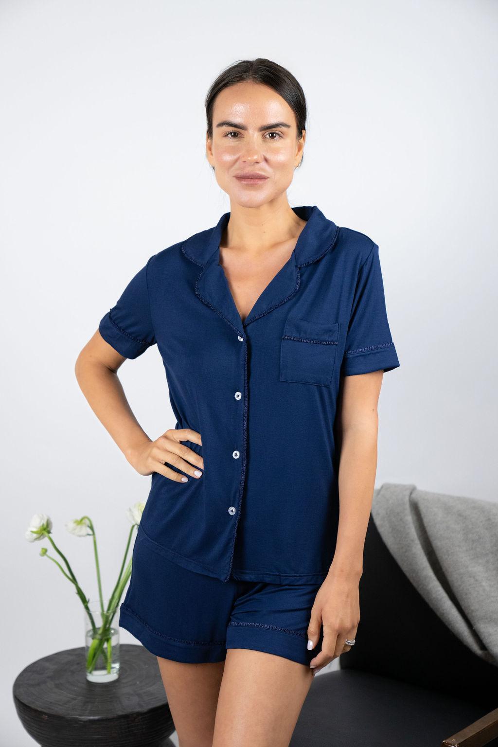 Model wearing Jolene Short Pajama Set in navy with ruffled piping and a short-sleeve button-down top.