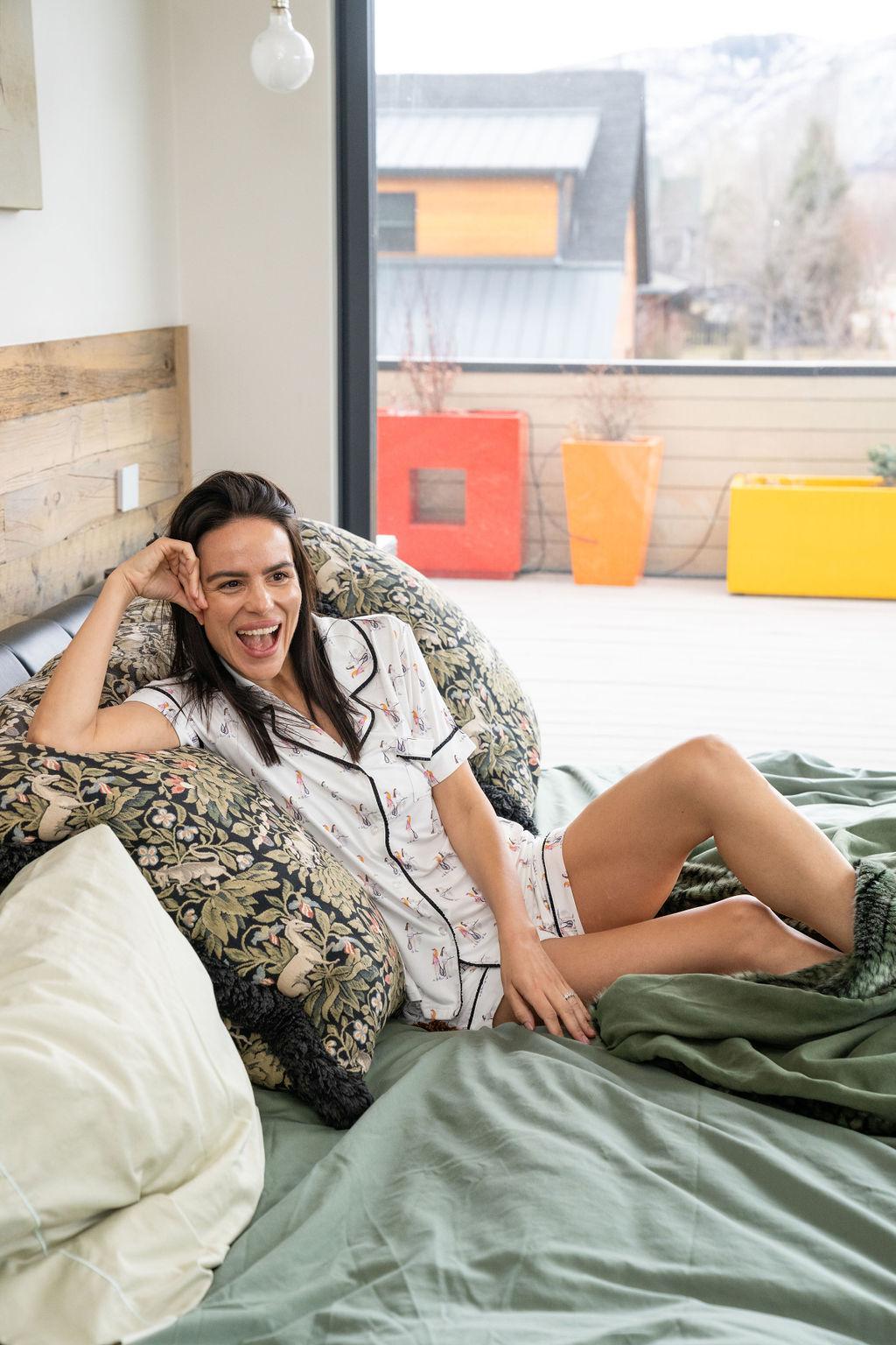 Model wearing Jolene Short Pajama Set with hand-drawn tennis print, black ruffled piping, and short-sleeve button-down top