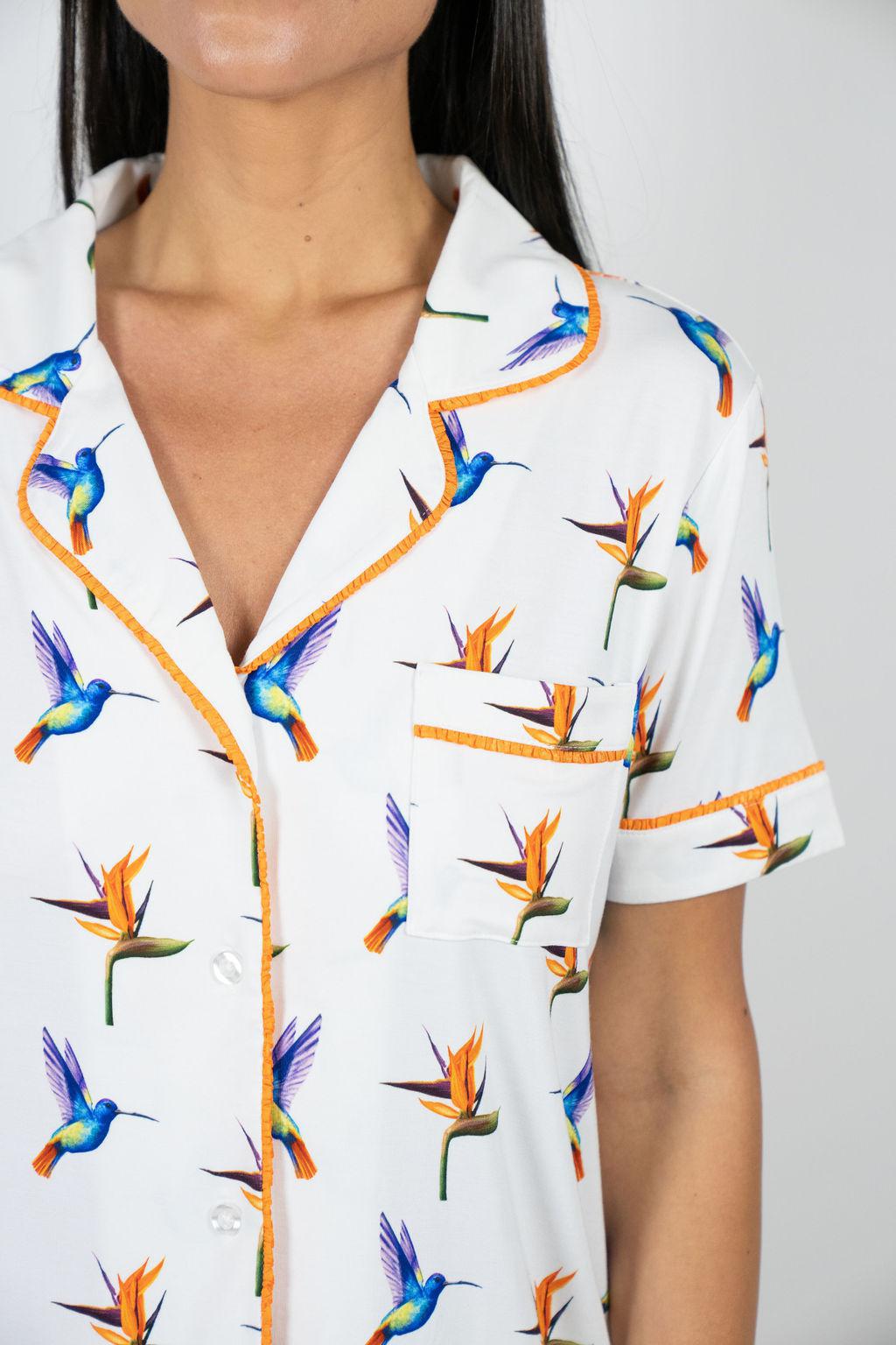 Close-up of hand-drawn hummingbird print on the Jolene pajama top with contrast piping