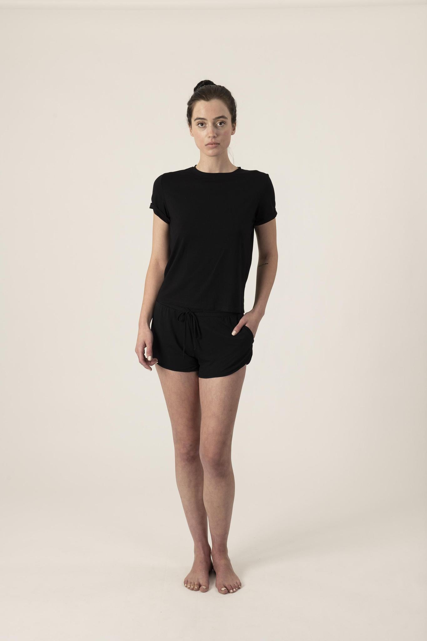 Model wearing Black lounge short set with rolled sleeve top and drawstring shorts