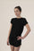 Model wearing Black lounge short set with rolled sleeve top and drawstring shorts