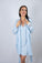 Model wearing Nora Short Robe in Ice Melt blue with lace detail and sewn-in belt