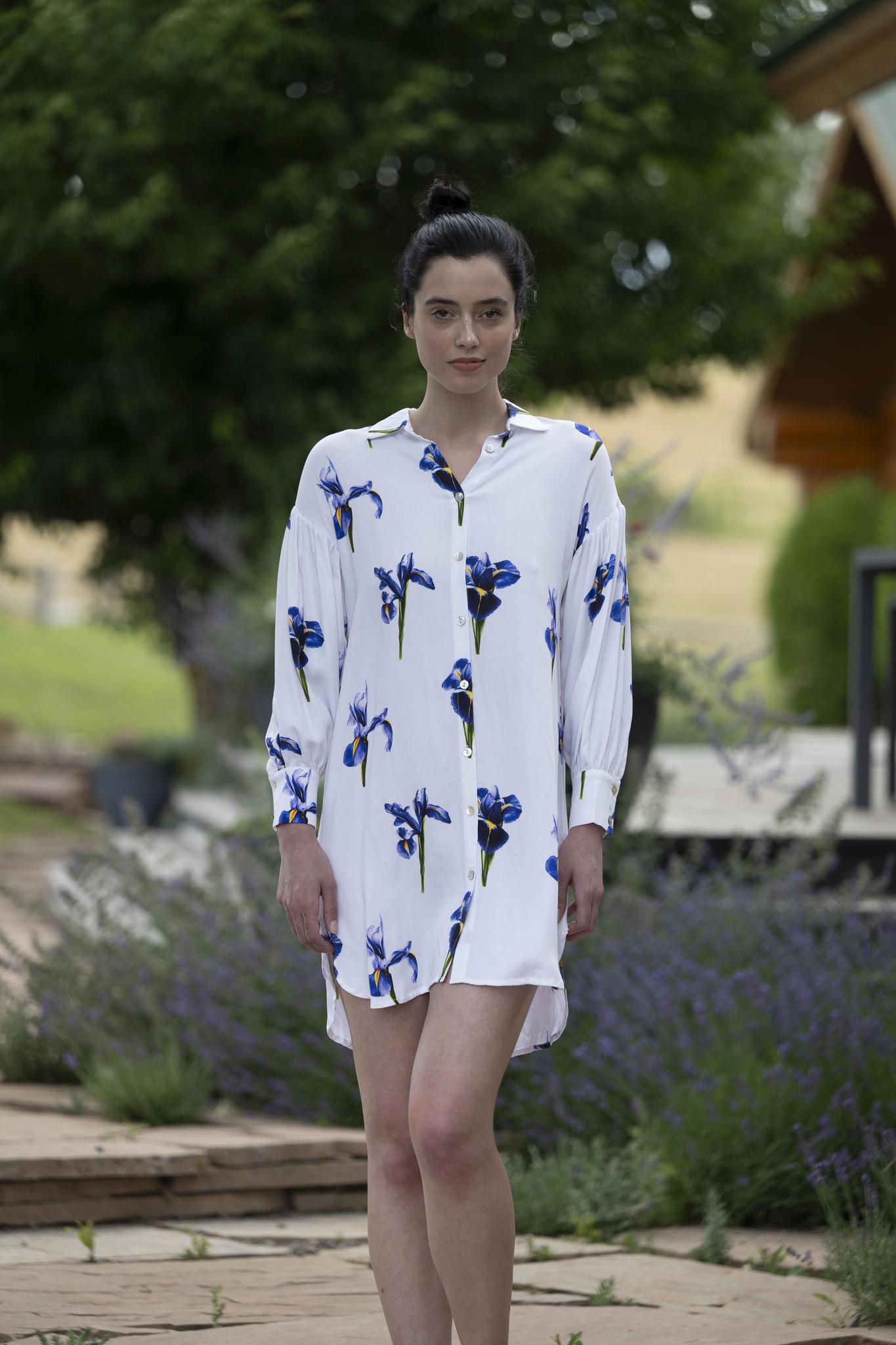 Model wearing silky satin dress with iris print, shirt collar, button-down front, and long gathered sleeves