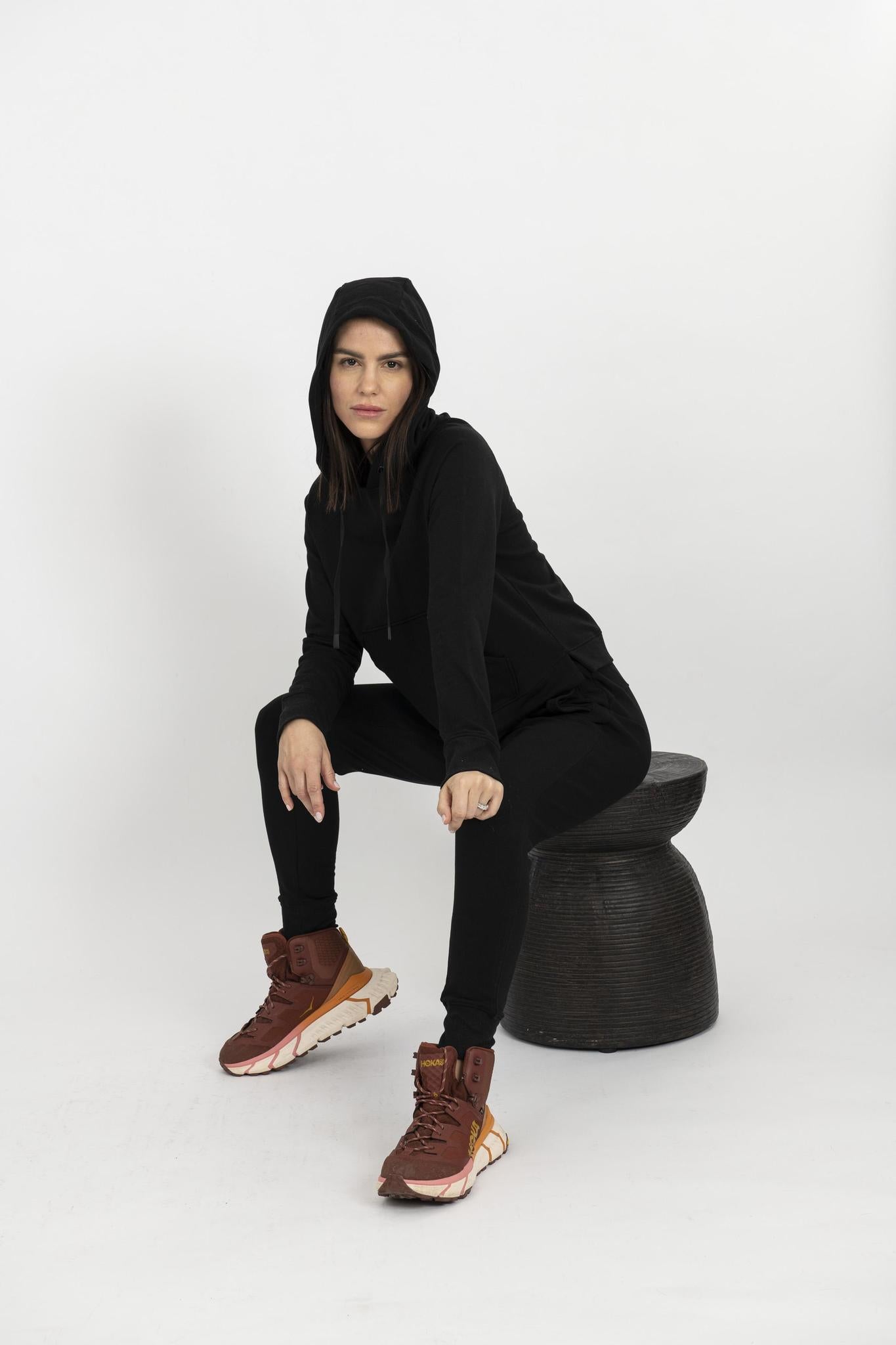 Model wearing black Tatum track suit with hooded sweatshirt and drawstring jogger pants