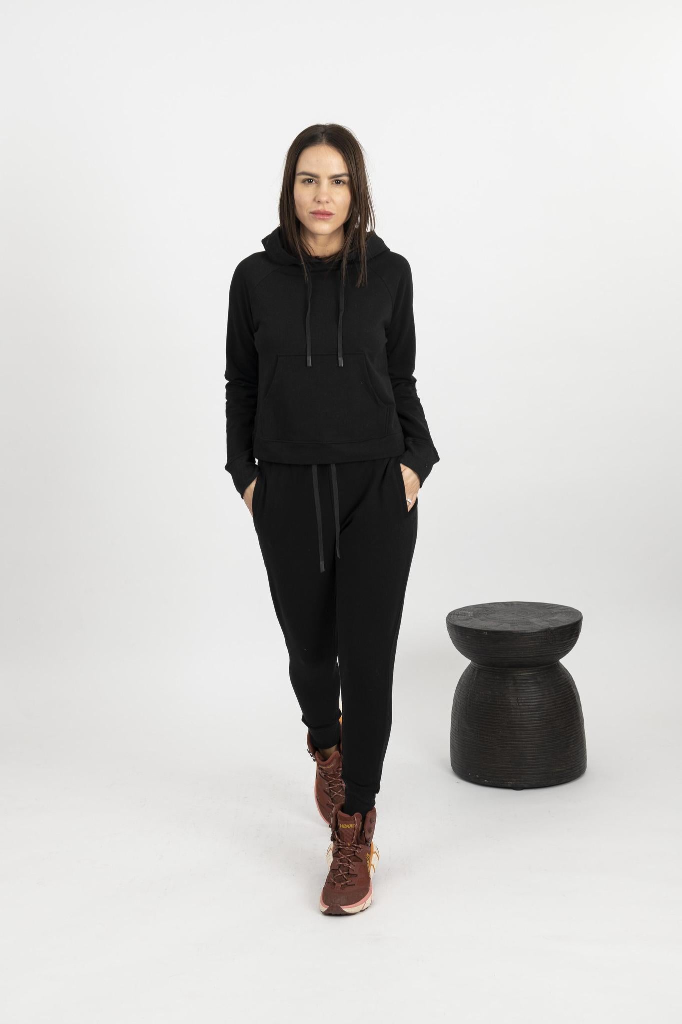 Model wearing black Tatum track suit with hooded sweatshirt and drawstring jogger pants