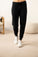 Model wearing the Cozy Banded Joggers in black, relaxed fit, tapered leg, and adjustable drawstring waist.